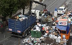 Jerusalem municipality workers clear garbage in the center of Jerusalem Sunday. (photo credit: Kobi Gideon/Flash90)