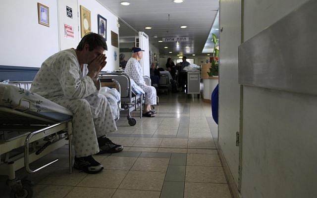 An Israeli patient waits in the corridor of the Barzlai Medical Center. Nurses from Barzilai Hospital in Ashkelon and Soroka hospital in Beersheva left their stations for two hours to protest an excessive work burden. February 15, 2012. (photo credit:Tsafrir Abayov/Flash90