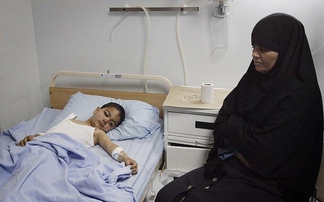 The mother of a boy injured in the bus accident keeps vigil in the hospital Thursday. (photo credit: Miriam Alster/Flash90)