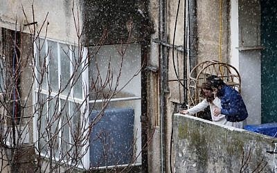 Young Israelis look at the snow falling down in Jerusalem. (photo credit: Miriam Alster/Flash 90)