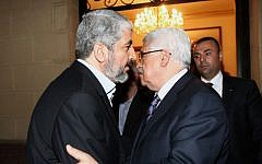 Hamas leader Khaled Mashaal (left) meets with Palestinian Authority President Mahmoud Abbas in Cairo, February 23, 2012 (photo credit: Mohammed al-Hums/Flash90)