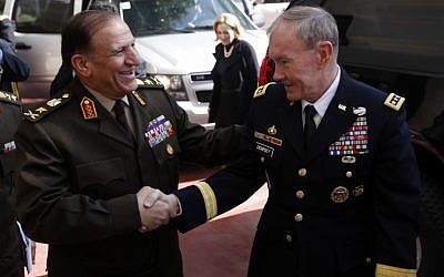 U.S. Chairman of the Joint Chiefs of Staff, Gen. Martin Dempsey, right, shakes hands with Lt. Gen. Sami Anan, left, upon his arrival to meet with Field Marshal Mohamed Hussein Tantawi, head of Egypt's ruling military council, at the Ministry of Defense in Cairo, Egypt, Saturday, Feb. 11, 2012. (photo credit: AP/Khalil Hamra, Pool)