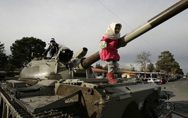 Iranian children play on top of a tank in a ceremony commemorating the 33rd anniversary of Iran's 1979 Islamic Revolution, last year in Tehran (photo credit: AP/Vahid Salemi) Iranian children play on top of a tank in a ceremony commemorating the 33rd anniversary of Iran's 1979 Islamic Revolution, last year in Tehran (photo credit: AP/Vahid Salemi)