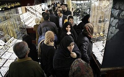 Iranians walk at the gold market of Tehran's old main bazaar. (photo credit: AP)