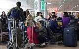 Illustrative: Passengers waiting at Ben Gurion Airport (AP/Sebastian Scheiner)