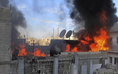 Syrian government shelling in Homs on February 22, 2012 (photo credit: AP/Local Coordination Committees in Syria)