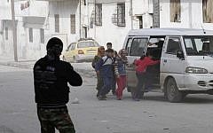 Civilians fleeing Syrian tanks in Idlib Tuesday (photo credit: AP)
