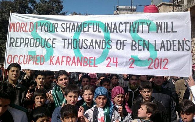 In this Feb. 24, 2012 imageanti-Syrian regime protesters hold a banner during a demonstration, in Kafranbel near Idlib, north Syria. (photo credit:AP/Local Coordination Committees in Syria) In this Feb. 24, 2012 imageanti-Syrian regime protesters hold a banner during a demonstration, in Kafranbel near Idlib, north Syria. (photo credit:AP/Local Coordination Committees in Syria)
