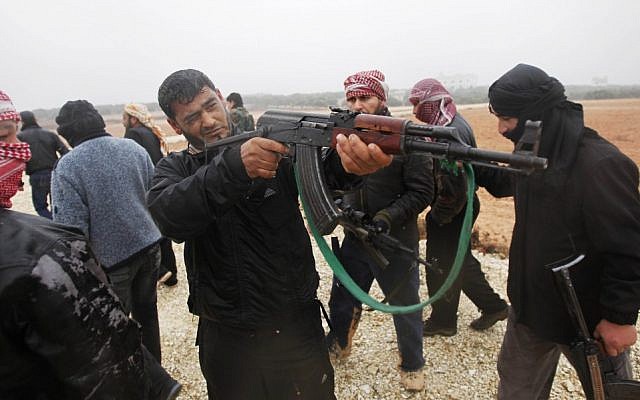 A member of the Free Syrian Army takes aim during weapons training outside Idlib, Syria, (photo credit: AP) A member of the Free Syrian Army takes aim during weapons training outside Idlib, Syria, (photo credit: AP)