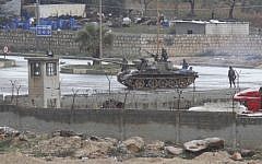 Illustrative photo of a tank rolling through a Syrian city earlier this year. (photo credit: AP)