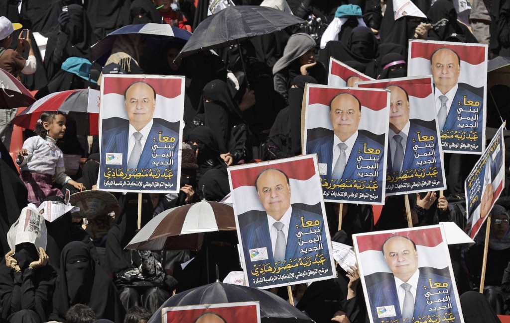 Yemeni women hold campaign posters that reads, 'Together we build a new Yemen, Abed Rabbo Mansour Hadi,' during a pro-election rally in Sanaa on Monday (photo credit: AP/Hani Mohammed)