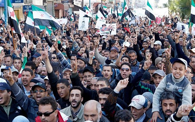 Demonstrators  in Casablanca, Morocco, show solidarity with the Syrian people (photo credit: AP/Abdeljalil Bounhar)
