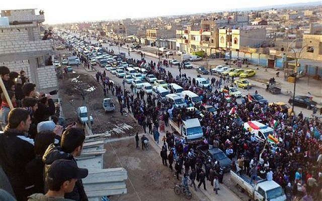 In this Wednesday, Feb. 22, image provided by the Local Coordination Committees in Syria, anti-Syrian regime protesters hold up Kurdish flags during a rally in the northeastern town of Qamishli, Syria. (AP /Local Coordination Committees in Syria) In this Wednesday, Feb. 22, image provided by the Local Coordination Committees in Syria, anti-Syrian regime protesters hold up Kurdish flags during a rally in the northeastern town of Qamishli, Syria. (AP /Local Coordination Committees in Syria)