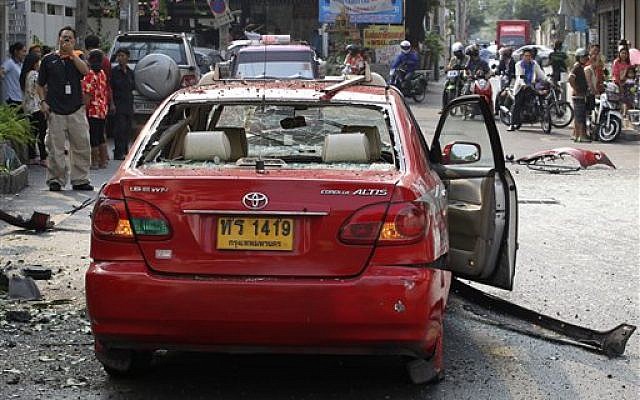 Wreckage of a taxi lies on the road at the site of an explosion in Bangkok on Tuesday. (AP Photo/Apichart Weerawong) Wreckage of a taxi lies on the road at the site of an explosion in Bangkok on Tuesday. (AP Photo/Apichart Weerawong)
