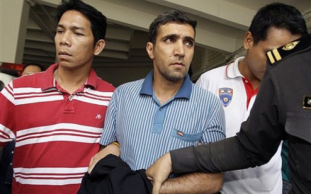 Thai immigration officers escort detained Iranian Mohammad Kharzei, center, at the immigration headquarters in Bangkok on Thursday. Kharzei and two fellow Iranians arrested after accidentally setting off an explosives cache in Bangkok were planning to attack Israeli diplomats, Thailand's police chief said. (AP Photo/Sakchai Lalit) Thai immigration officers escort detained Iranian Mohammad Kharzei, center, at the immigration headquarters in Bangkok on Thursday. Kharzei and two fellow Iranians arrested after accidentally setting off an explosives cache in Bangkok were planning to attack Israeli diplomats, Thailand's police chief said. (AP Photo/Sakchai Lalit)