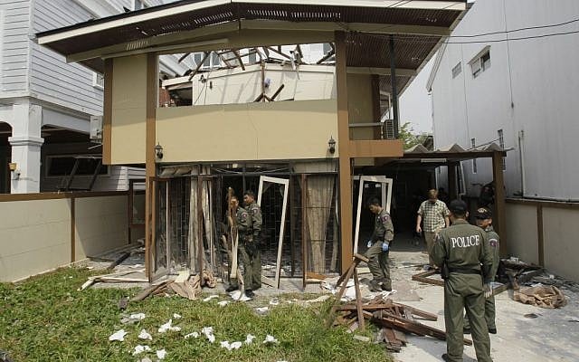 Thai Explosive Ordnance Disposal (EOD) officials examine the damage caused by a blast at the house where suspected bombers were staying in Bangkok, Thailand. (photo credit: AP/Sakchai Lalit)