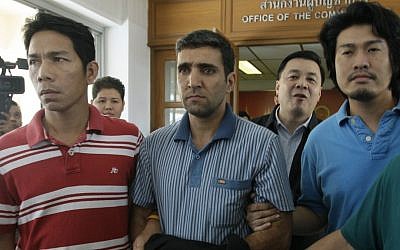Thai immigration officers escort detained Iranian Mohammad Kharzei (center) at immigration headquarters in Bangkok. (photo credit: AP)