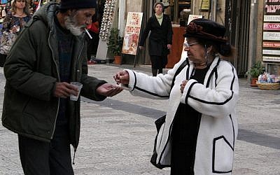 A homeless man begs for money in Jerusalem. (Photo credit: Melanie Fidler /Flash90)
