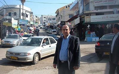 Zidan Badran, mayor of the Israeli portion of the Arab town of Barta’a, stands on the seam that separates the Israeli part of town from its West Bank portion. (photo credit: Linda Gradstein/JTA) Zidan Badran, mayor of the Israeli portion of the Arab town of Barta’a, stands on the seam that separates the Israeli part of town from its West Bank portion. (photo credit: Linda Gradstein/JTA)