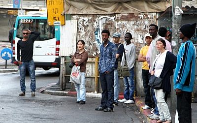 Tel Aviv residents wait for the bus (photo credit: Nicky Kelvin/Flash90)