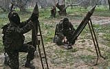 Islamic Jihad members firing rockets into Israel from the Gaza Strip. (photo credit: CC BY-SA Amir Farshad Ebrahimi, Flickr)
