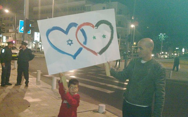Tel Avivis demonstrating support for the Syrian people and opposition to Assad on Saturday night. (photo credit: @Elizrael, Twitter)