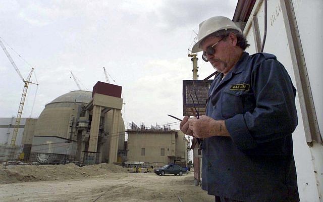 A worker outside the Bushehr nuclear power plant in Iran (photo credit: AP/Vahid Salemi)