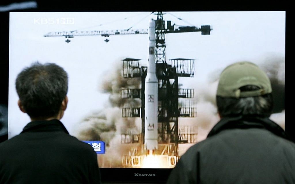 South Koreans watch the 2009 launch of a North Korean missile on TV (photo credit: AP/Ahn Young-joon)