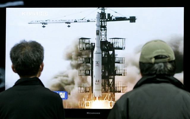 South Koreans watch the 2009 launch of a North Korean missile on TV (photo credit: AP/Ahn Young-joon)