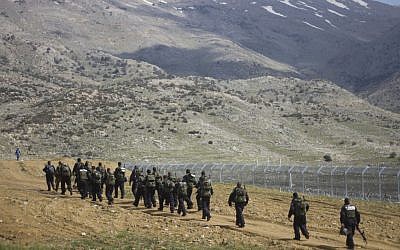 Israeli riot police men march along the border between Majdal Shams in the Golan Heights, and Syria in March. (AP Photo/Ariel Schalit)