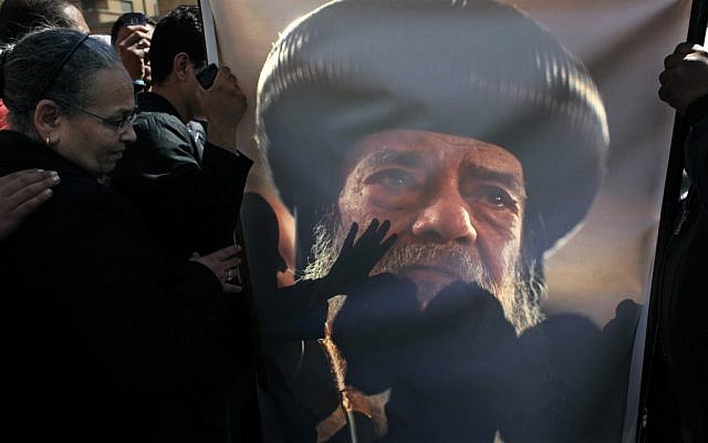 Coptic mourners kiss a picture of the late Pope Shenouda III (photo credit: AP/Nasser Nasser)