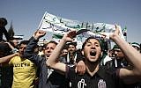 Syrians chant anti-Assad slogans in front of the Syrian embassy during a protest in Amman, Jordan, on Friday. The Arabic banner reads, "I love my country and the Free Syrian Army." (photo credit: AP Photo/Mohammad Hannon)