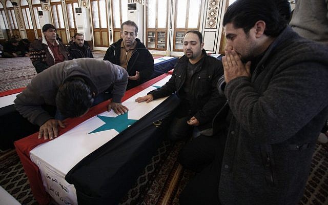 The funeral of Damascus bombing victims Sunday (photo credit: AP/Muzaffar Salman)