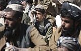 Afghan villagers pray for the victims in Kandahar (photo credit: AP/Allauddin Khan)
