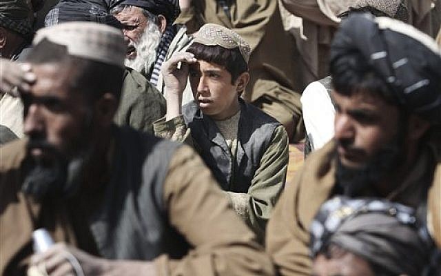 Afghan villagers pray for the victims in Kandahar (photo credit: AP/Allauddin Khan) Afghan villagers pray for the victims in Kandahar (photo credit: AP/Allauddin Khan)