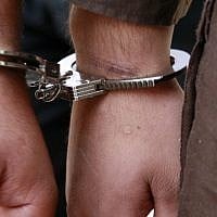 Illustrative. A man's hands in handcuffs. (Olivier Fitoussi/Flash90)