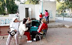 Israelis sit near a bomb shelter in the southern city of Netivot during operation Cast Lead in December 2008 (photo credit: Roni Schutze/Flash 90)