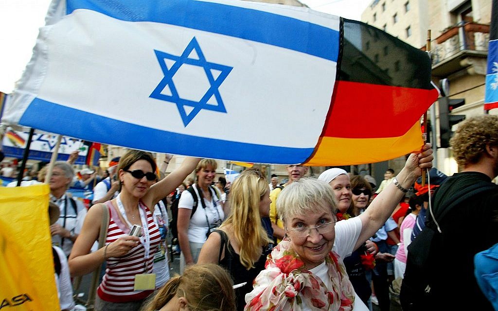 Illustrative: A German Christian raises an Israeli-German flag in the air during the Feast of the Tabernacles in Jerusalem (photo credit: Olivier Fitoussi/Flash90)