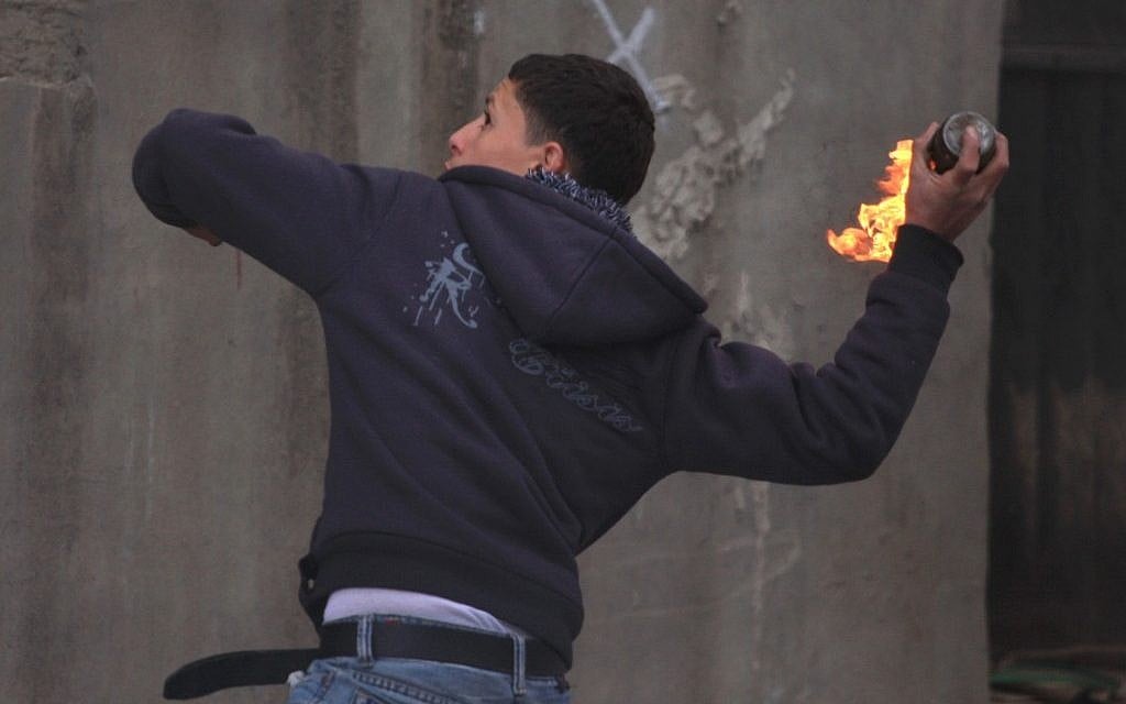 Illustrative. A Palestinian throws a firebomb. (Issam Rimawi/Flash90)