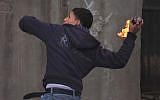 Illustrative. A Palestinian throws a firebomb. (Issam Rimawi/Flash90)