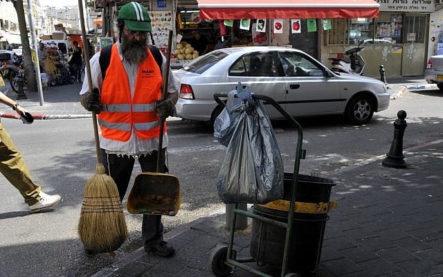 An ultra-Orthodox Israeli works as a street cleaner. A new study says more ultra-Orthodox men are joining the workforce (photo credit: Serge Attal/Flash 90)