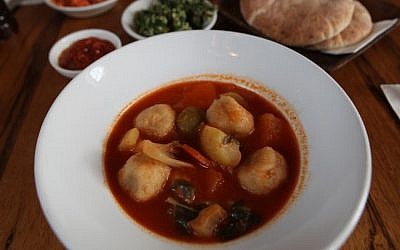 A bowl of kubbeh soup and side salads (photo credit: Yossi Zamir/Flash90)