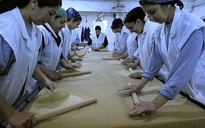 Women working in a matza factory (photo credit: Tsafrir Abayov/Flash90)