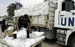 Palestinians receive food aid at the refugee camp of Rafah in the southern Gaza Strip (photo credit: Abed Rahim Khatib/Flash 90)