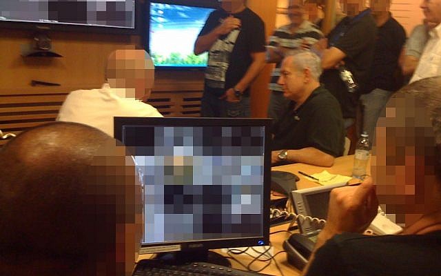 Prime Minister Benjamin Netanyahu gets briefed at the Foreign Ministry situation room during the rescue of Israeli security personnel from the stormed embassy in Cairo last September. (photo credit: GPO/Flash90)