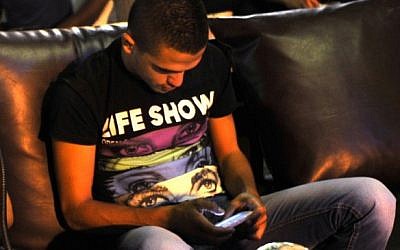 Relaxing with a mobile game in Jerusalem (photo credit: Serge Attal/Flash 90)