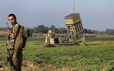 A soldier standing near an Iron Dome battery, part of Israel's missile defense system (photo credit: Tsafrir Abayov/Flash90)