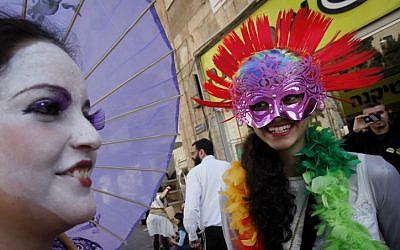 Israelis wearing costumes before the Jewish holiday of Purim, when it is customary to dress up. (photo credit: Miriam Alster/Flash90)