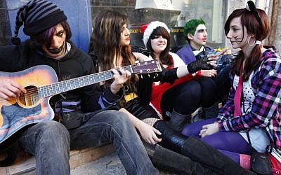 Israelis teens jamming in costume on the streets in Jerusalem. (Miriam Alster/Flash90)