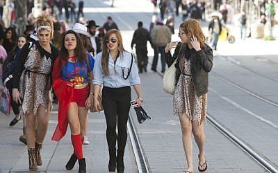Israeli women dressed up in costumes for the Jewish holiday of Purim walk on Jaffa Street in downtown Jerusalem. (photo credit: Yonatan Sindel/Flash90)